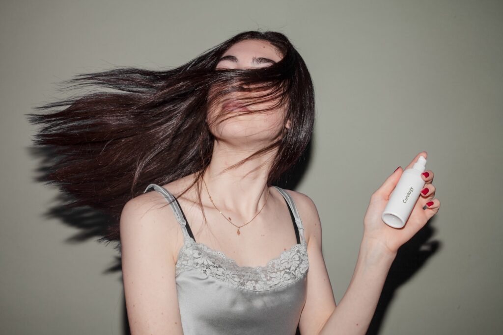 woman holding spray bottle