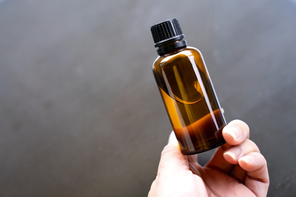 Hand holding amber glass bottle